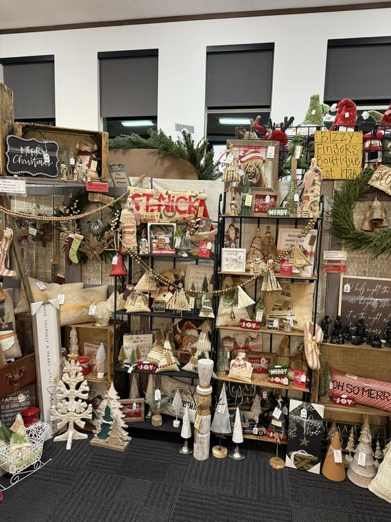 Rustic Christmas decor and wooden trees on display shelves