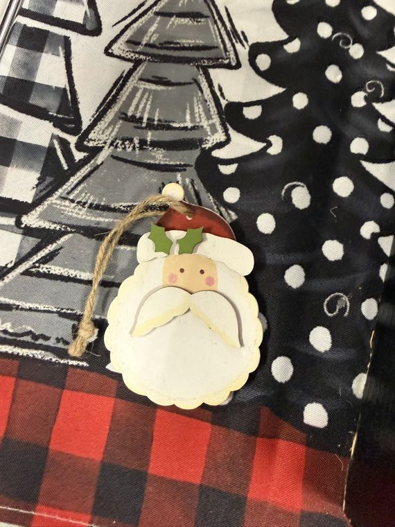 A hand-painted wooden Santa ornament