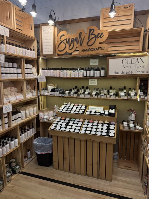 Handcrafted lotions and soaps on warmly lit wooden shelves